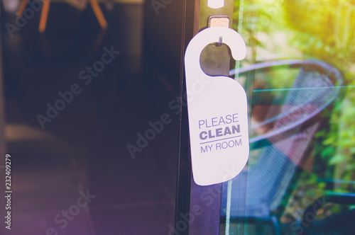 Cleaning room service text hanging on the door 