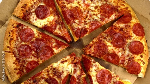 Spaced out slices pepperoni pizza spinning video close up