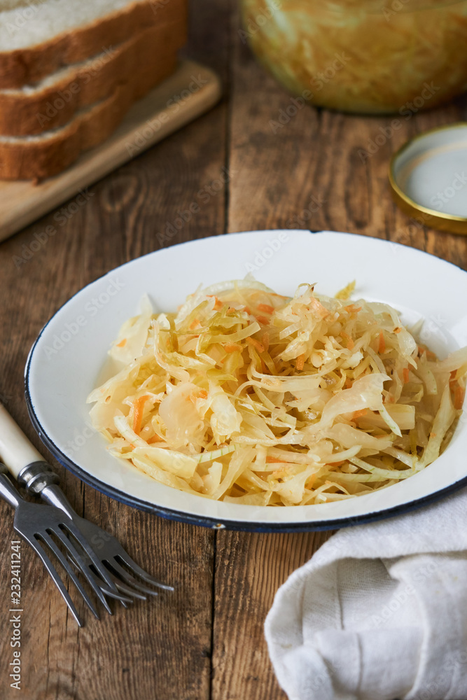 Sauerkraut with onions in a bowl on a wooden table Sauerkraut with onions in a bowl on a wooden table