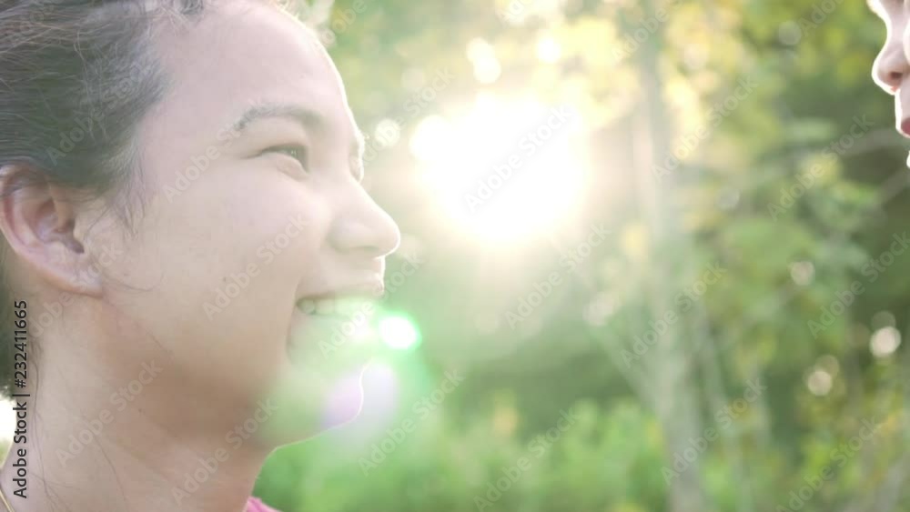 Beauty mum and her daughter are kissing and hugging happy family in park together. Happy mother's day. Slow motion shot in 50 fps. Beauty mum and her daughter are kissing and hugging happy family in park together. Happy mother's day. Slow motion shot in 50 fps.