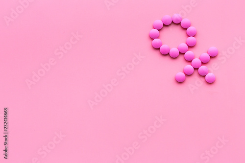 Female diseases. Female gender icon symbol made of pills on pink background top view copy space