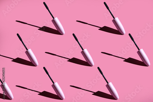  many mascara brushes on a pink background hard light