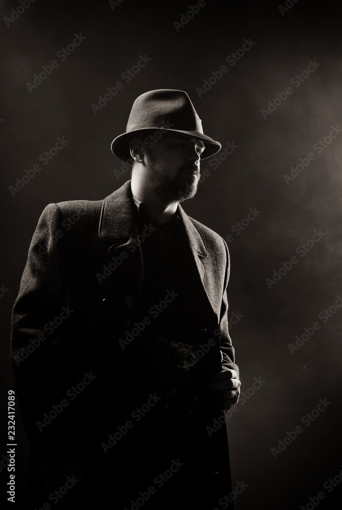 man in a black hat and coat on a dark background, Studio photo man in a black hat and coat on a dark background, Studio photo