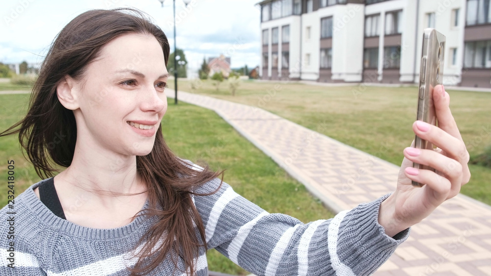 Blogger tells the story to her subscribers, shooting herself on a mobile phone, selfie video. Blogger tells the story to her subscribers, shooting herself on a mobile phone, selfie video.