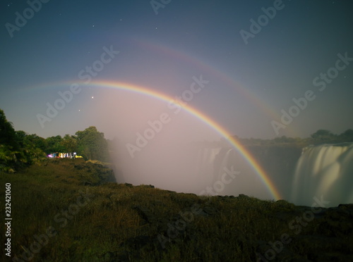 Victoria Falls,Zimbabwe-August 17, 2016: A lunar rainbow or a moonbow on the Victoria Falls observed within 2 days of full moon. 
