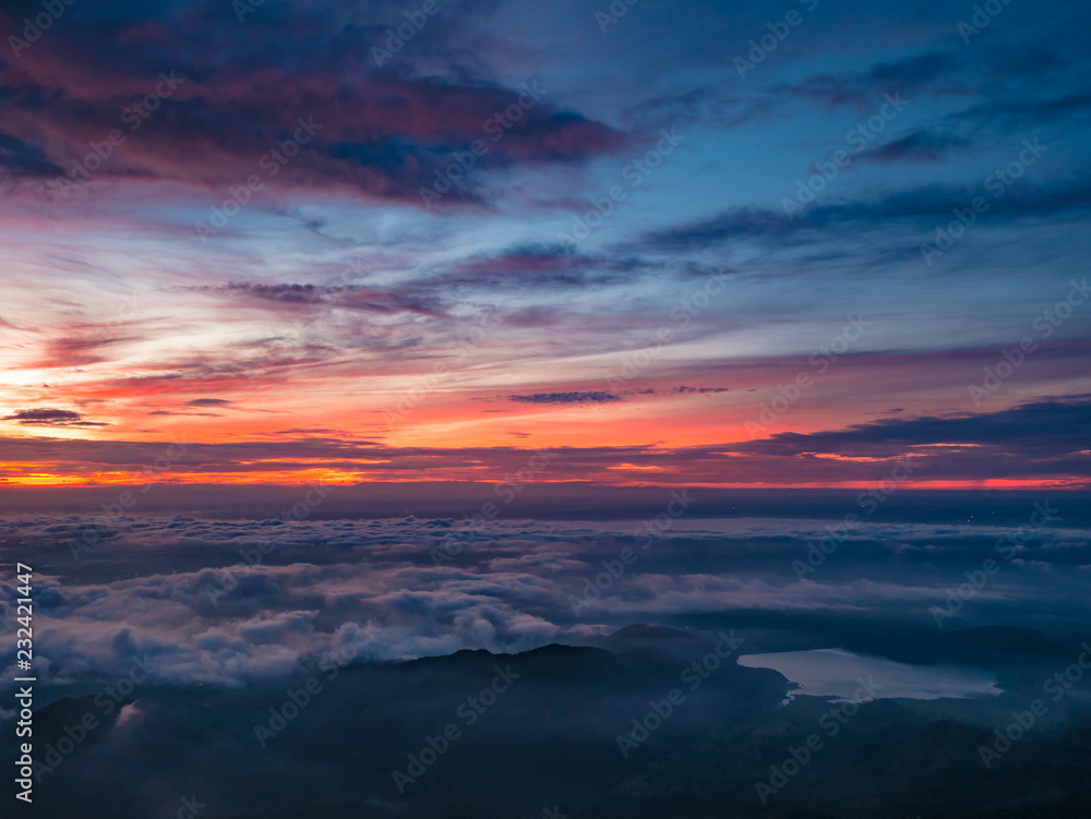 Beautiful Sunrise Sky with Sea of the mist of fog and heart shaped lake  in the morning on Khao Luang mountain in Ramkhamhaeng National Park,Sukhothai province Thailand