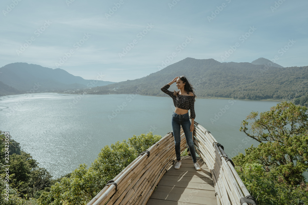stylish young woman taking picture for social media in nature