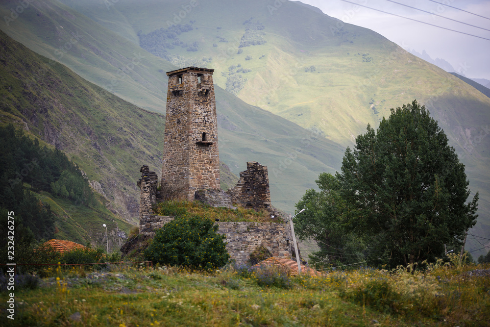 Old dilapidated watchtower in the village of SNO, Georgia. Mountain valley of a small authentic village. Old dilapidated watchtower in the village of SNO, Georgia. Mountain valley of a small authentic village.