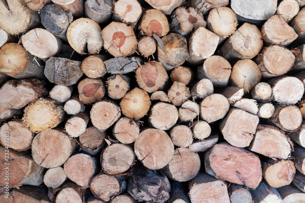 Dry firewood laid in a heap for kindling the furnace, wood pile background Dry firewood laid in a heap for kindling the furnace, wood pile background