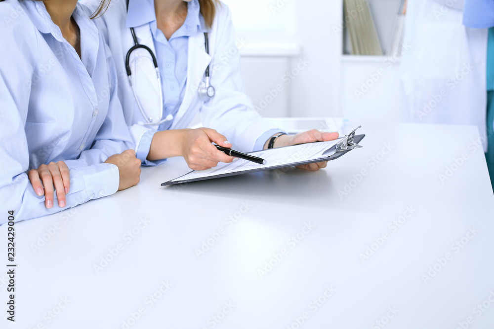 Doctor and patient are discussing something, just hands at the table. Medicine concept Doctor and patient are discussing something, just hands at the table. Medicine concept