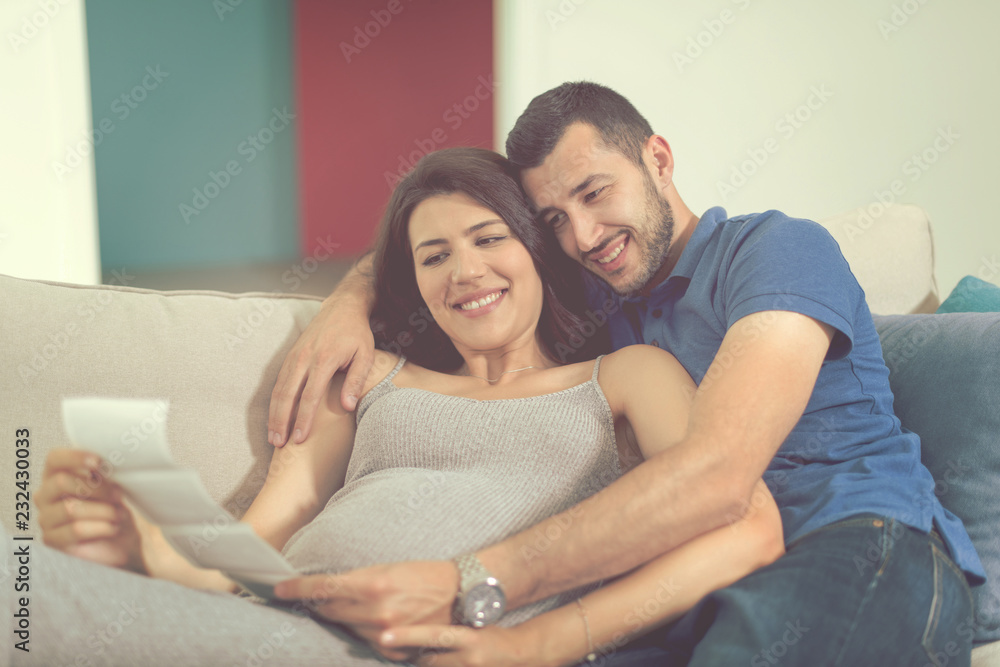 pregnant couple looking baby's ultrasound pregnant couple looking baby's ultrasound