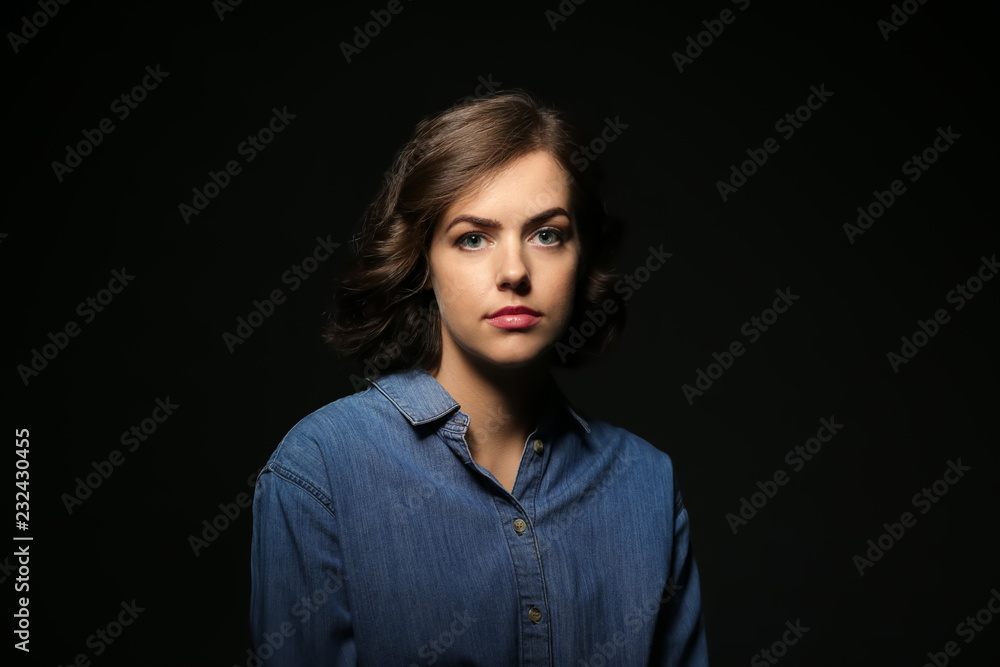 Portrait of beautiful young woman on dark background Portrait of beautiful young woman on dark background