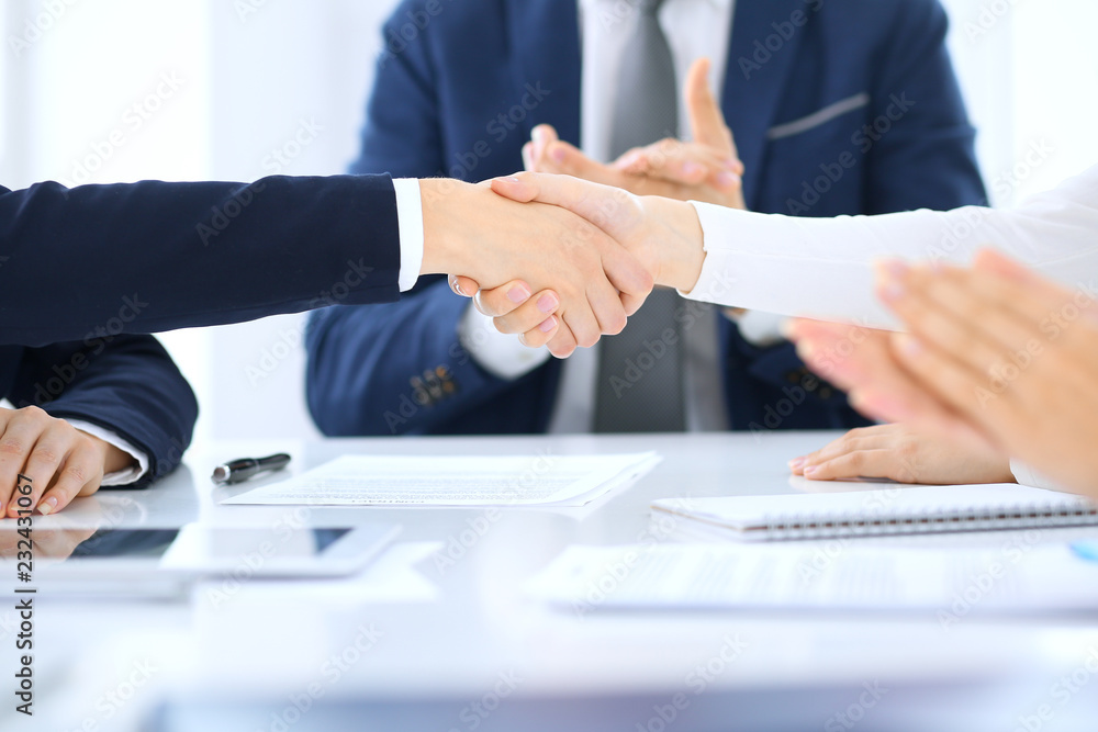 Group of business people or lawyers shaking hands finishing up a meeting , close-up. Success at negotiation and handshake concepts Group of business people or lawyers shaking hands finishing up a meeting , close-up. Success at negotiation and handshake concepts