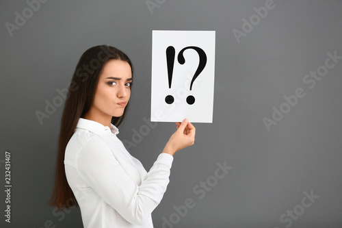 Thoughtful young woman hold...