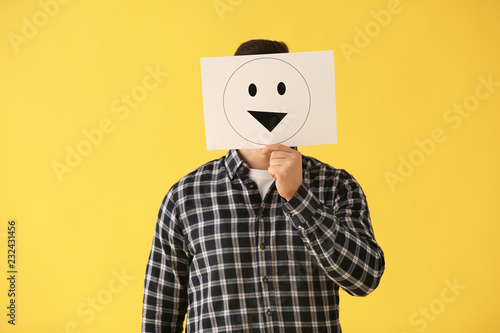 Man hiding face behind shee...
