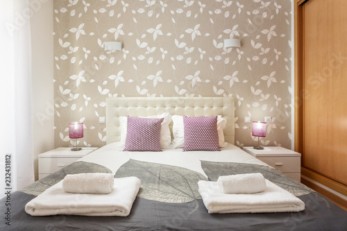 Modern bedroom with pillows and a bed for tourists. Frontally.
