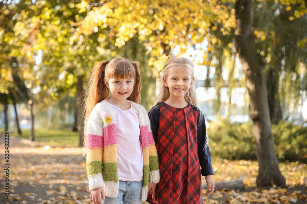 Cute little girls in autumn park Cute little girls in autumn park