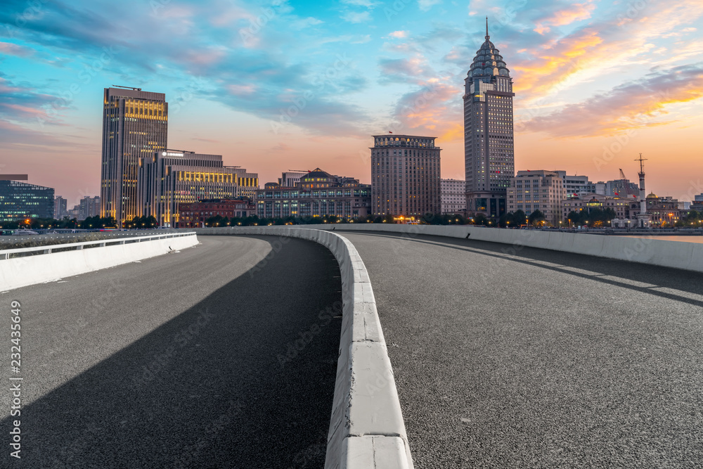Naklejka premium City skyscrapers and road asphalt pavement