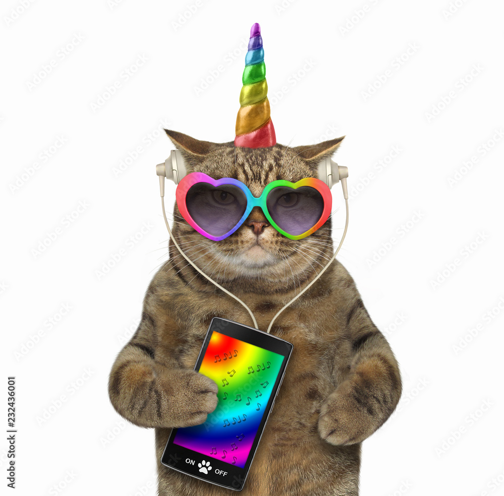 The unicorn cat in headphones is listening to music from a smartphone. White background.