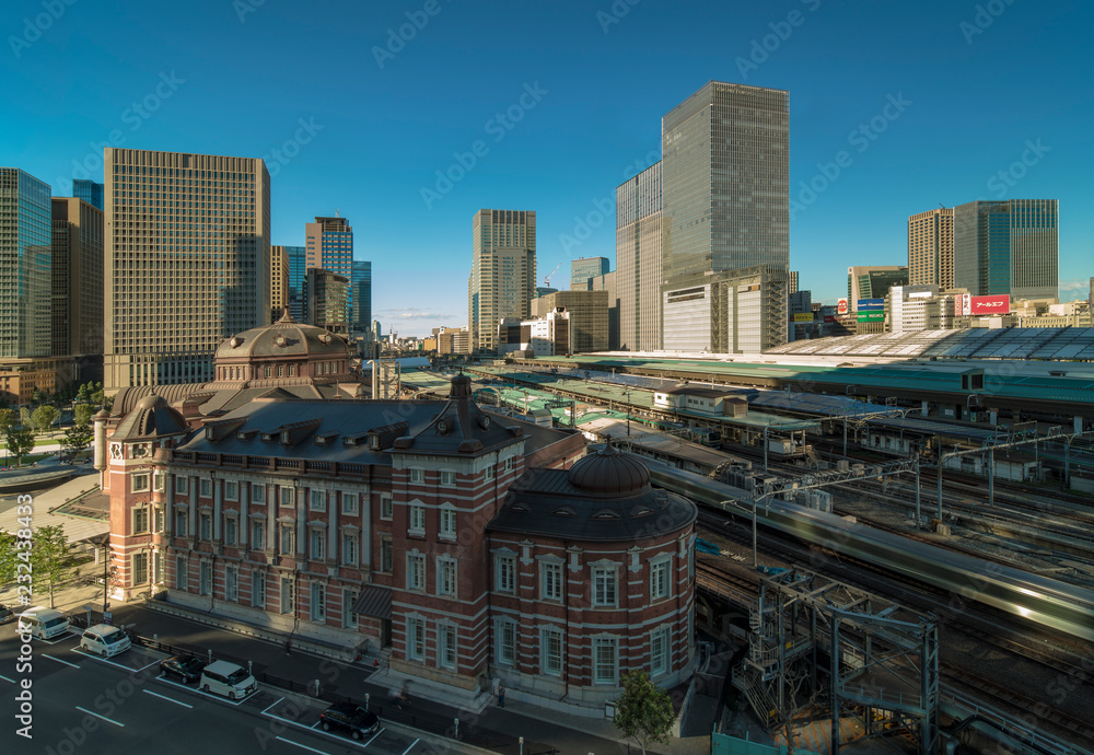 View of Marunouchi side of Tokyo railway station in the Chiyoda City, Tokyo, Japan. The station is divided into Marunouchi and Yaesu sides in its directional signage. View of Marunouchi side of Tokyo railway station in the Chiyoda City, Tokyo, Japan. The station is divided into Marunouchi and Yaesu sides in its directional signage.