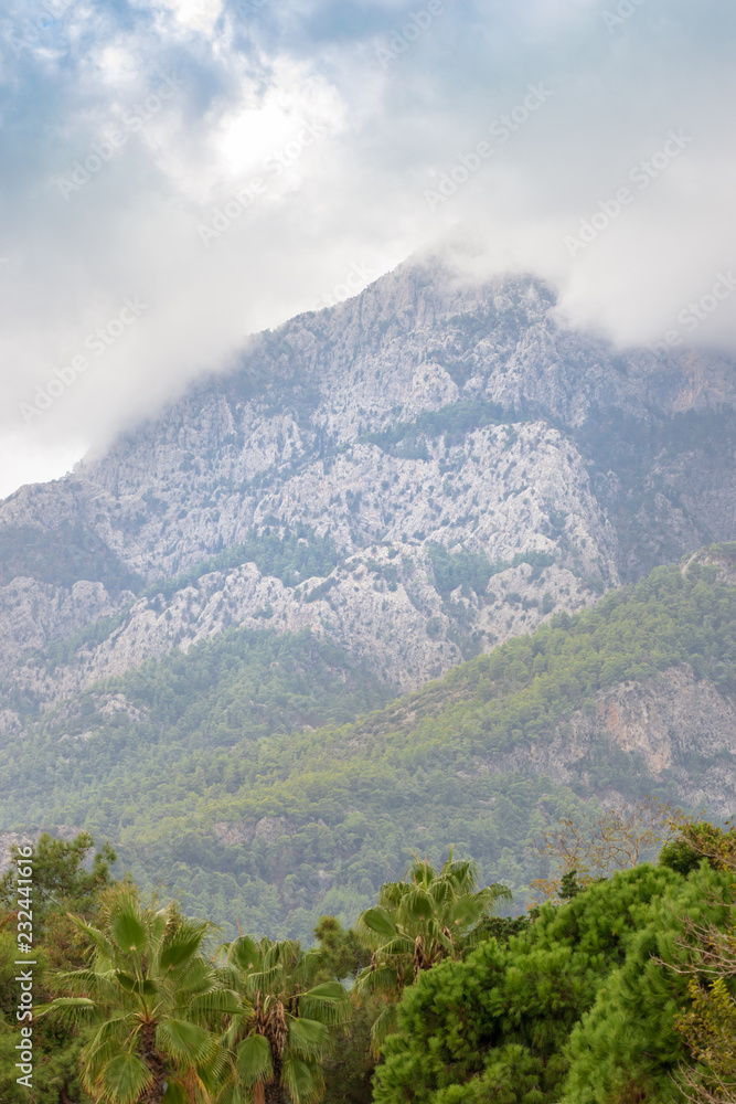 Rocky peaks of the Taurus Mountains during variable autumn weather, at the same time clouds and glimpses of the sun