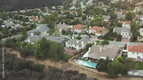 The Sunset over a residential area in between green mountiains in Southern California