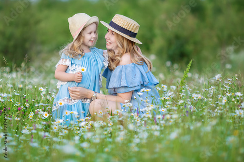 Happy mother and daughter child together with yellow dandelion flowers in summer day enjoy vacation free time together happy #232442486