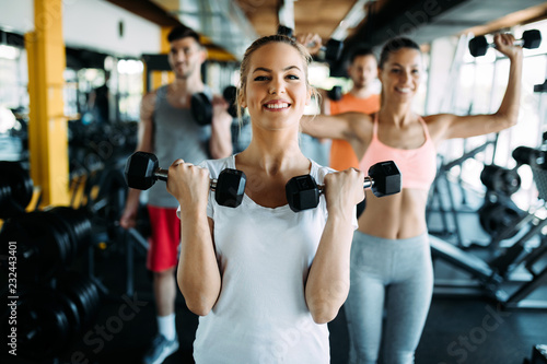 Group of people have workout in gym