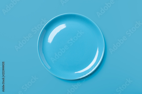 Blue pastel colored plate on blue background.
