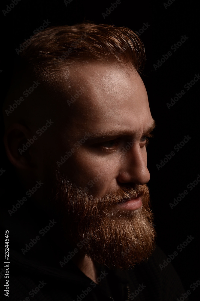 portrait of serious young man Isolated on black background and looking at camera Confident concept portrait of serious young man Isolated on black background and looking at camera Confident concept