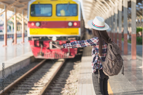Beautiful young asian woman waiting for train at train station, Travel and vacation concept.  Chinese tourists.
