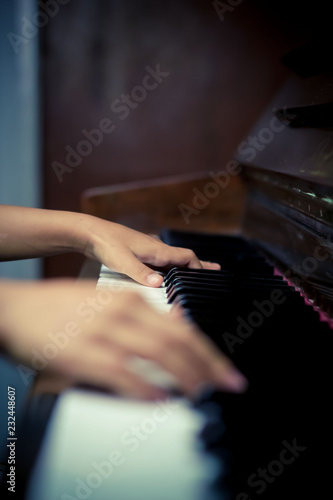 Hands Playing on Piano Keys