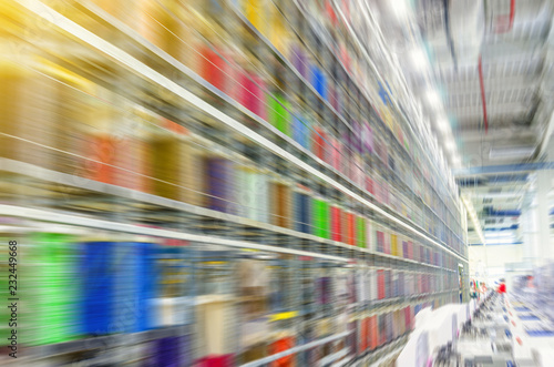 Large coils with colored electrical wires on huge shelves in an industrial plant. Manufacture of electrical wiring for cars. Employment in industry