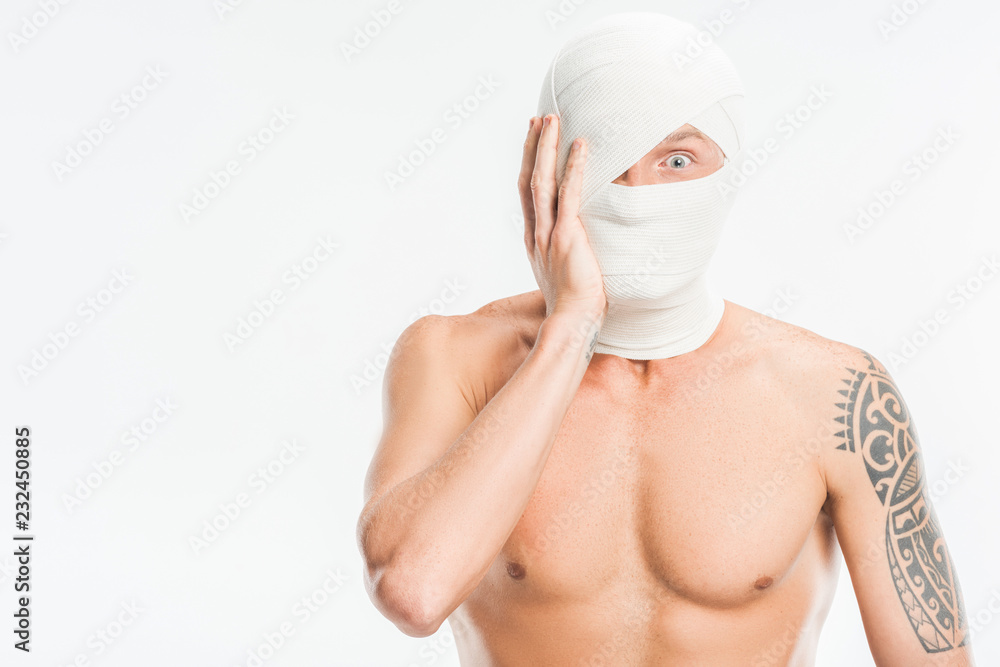 scared nude man with bandages over head after plastic surgery isolated on white scared nude man with bandages over head after plastic surgery isolated on white