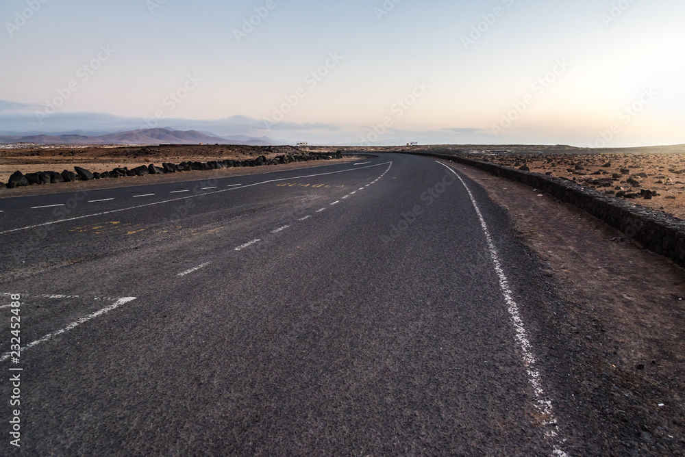 Naklejka premium Desertic road in Fuerteventura at sunset, Spain