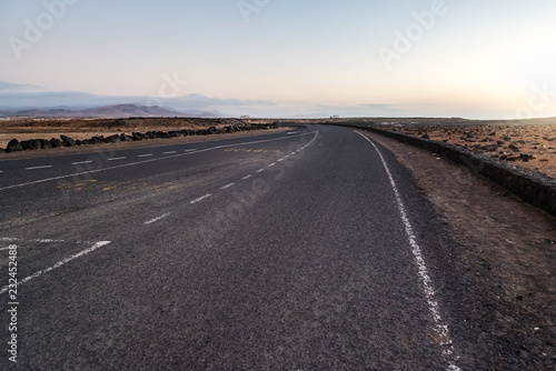 Desertic road in Fuerteventura at sunset, Spain