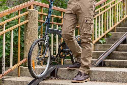 Man wearing cargo pants and his bicycle