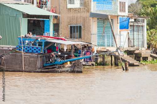Cai Be, Vietnam-December 10, 2013. Traditional vietnamese boat converted to house and it's a living area for poor people on the Mekong River on December 10, 2013 at Mekong Delta in Cai Be District    