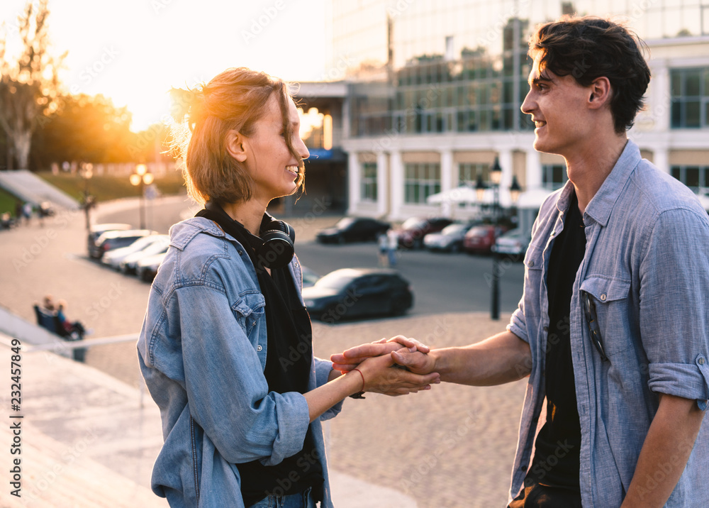 Lovely young hipster couple dating during summer sunset. they wear jeans clothes. modern youth relationship. Lovely young hipster couple dating during summer sunset. they wear jeans clothes. modern youth relationship.