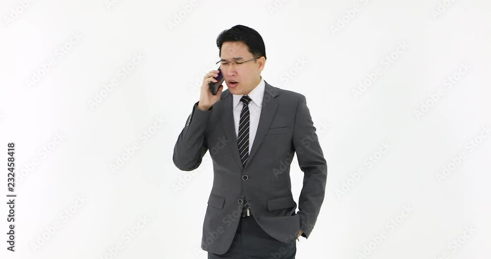 Asian business man in suit talking on mobile phone on white background. Asian business man in suit talking on mobile phone on white background.