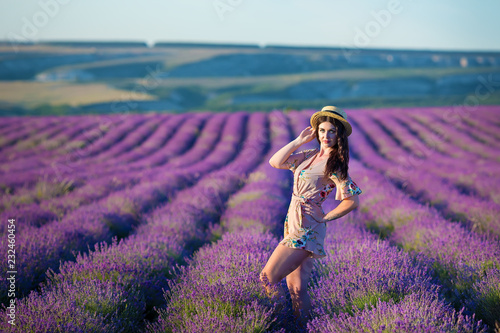 Fototapeta Naklejka Na Ścianę i Meble -  Young magic adorable woman in lavender field on summer day dancing and enjoy life time with woman girl power