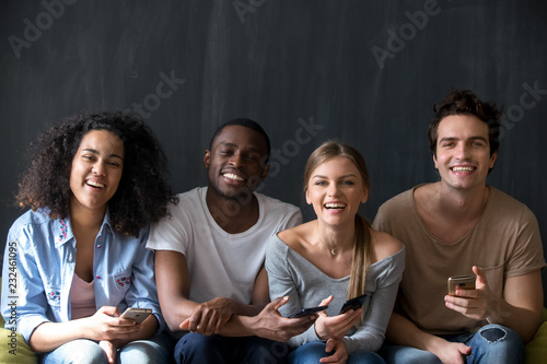 Foto Happy diverse students multiracial friends sitting together indoor