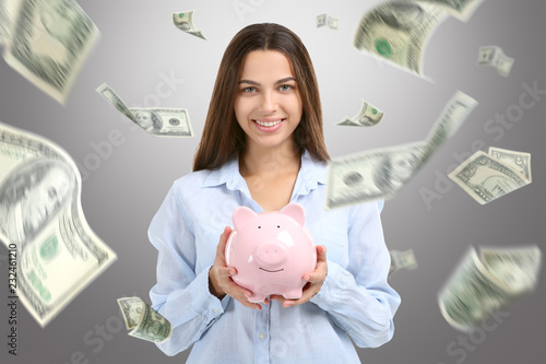 Happy rich woman with piggy...