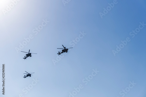Greek Air Force Apache helicopters flying. 
2 Boeing AH-64 attack helicopters flying at 28 October military parade, commemorating the Greek no against Italian 1940 ultimatum.