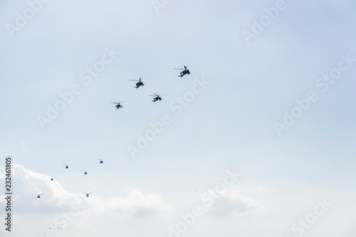 Greek Air Force helicopters flying. Helicopters like Boeing AH-64 Apache attack, Boeing CH-47 Chinook lift and Bell utility ones at 28 October military parade. 