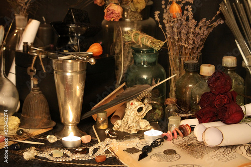 Antique Magic Book. Witchcraft Peacock feathers and candle background. Black candle Magic Ritual.