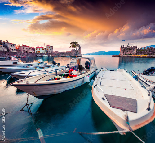 Colorful spring view of the Nafpaktos port. Fantastic sunrise in the Gulf of Corinth, Greece, Europe. Beauty of countryside concept background.