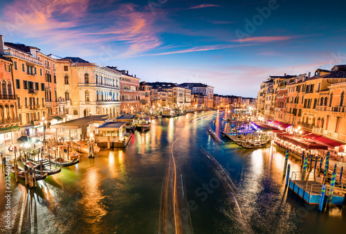 Great scene of famous Canal Grande. Colorful spring sunset from Rialto Bridge of Venice, Italy, Europe. Picturesque evening seascape of Adriatic Sea. Traveling concept background.