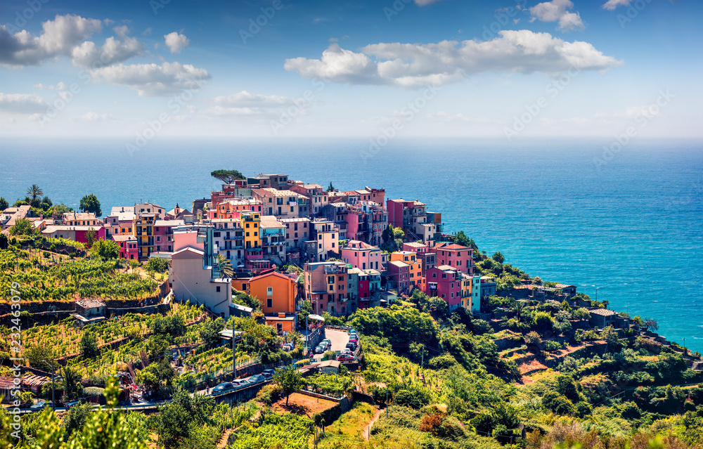 Third village of the Cique Terre sequence of hill cities - Corniglia. Colorful spring morning in Liguria, Italy, Europe. Picturesqie seascape of Mediterranean sea. Traveling concept background.