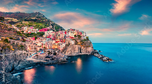 Fototapeta Naklejka Na Ścianę i Meble -  Second city of the Cique Terre sequence of hill cities - Manarola. Colorful spring sunset in Liguria, Italy, Europe. Picturesqie seascape of Mediterranean sea. Traveling concept background.